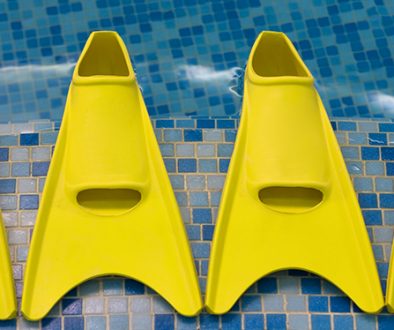 Four yellow flippers expecting swimmers